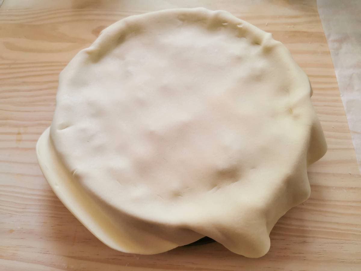 cake tin covered with second pastry dough sheet