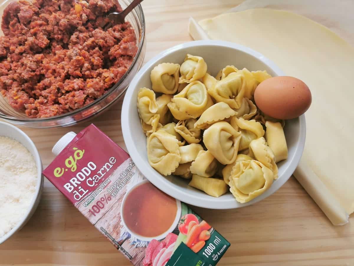 ingredients for tortellini pie on wood work surface.