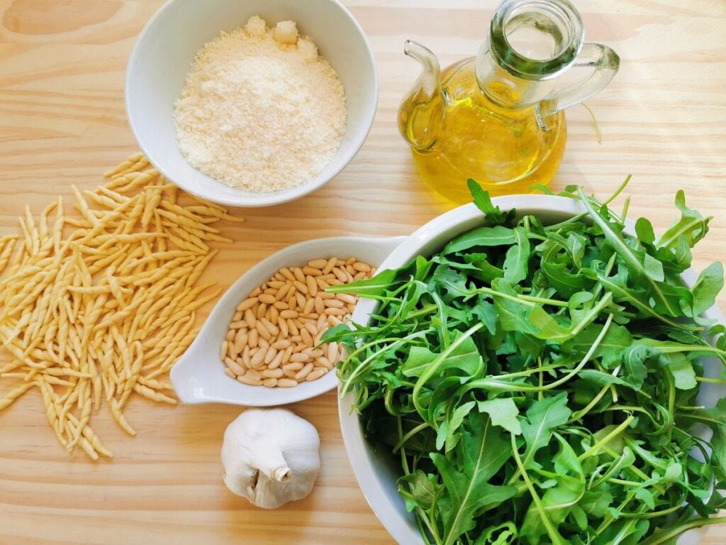 ingredients for trofie with rocket pesto on wooden board