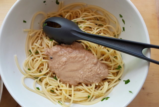 tuna and anchovy sauce on cooked vermicelli in white bowl