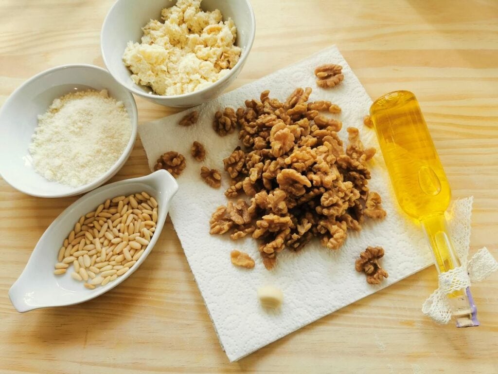 boiled walnuts, bread soaked in milk, pine nuts and grated parmigiano all in white bowls