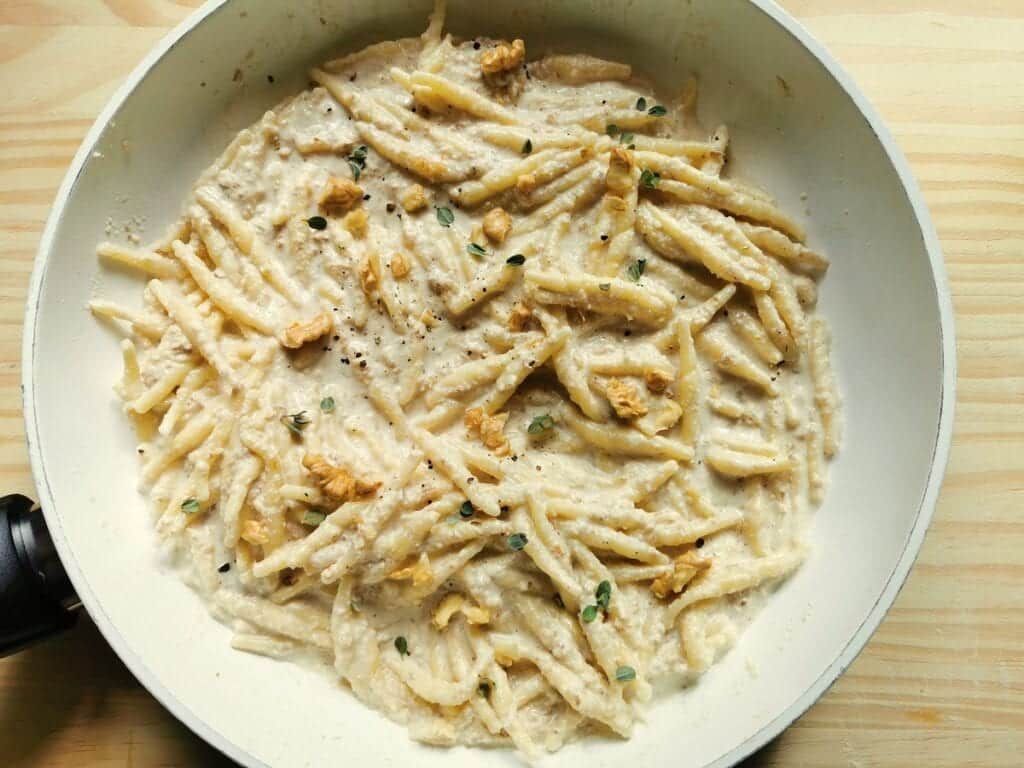 Ready walnut sauce with trofie pasta in pan