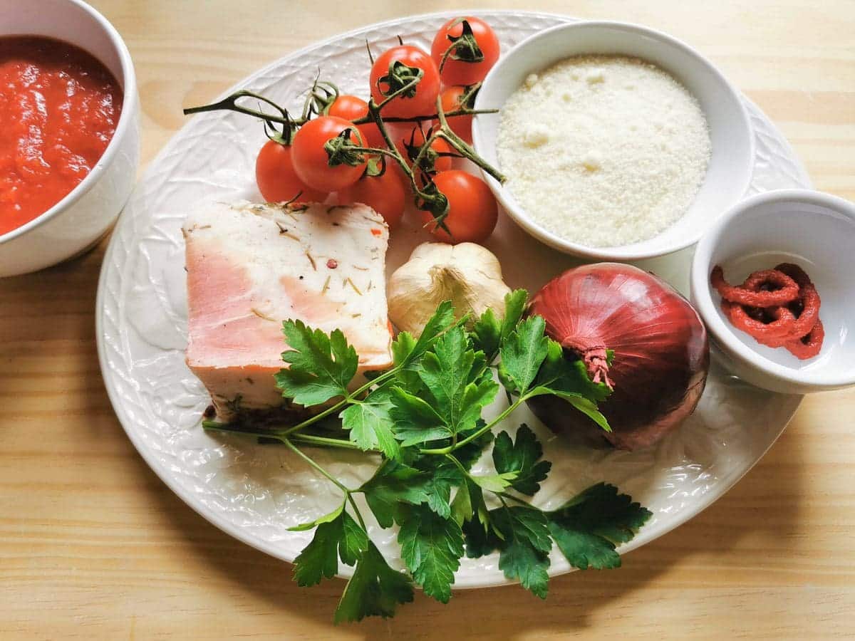 ingredients for ziti lardiati on white plate